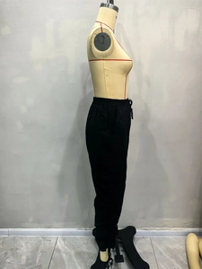 Detail of the elastic waistband with adjustable drawstring on black cargo jogger pants