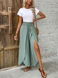 Detail view of high waist wide leg pants with side slits and elastic drawstring waist