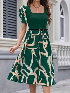 Detail of elegant puff sleeves and chic square neckline on the green knit dress