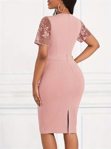 Elegant dusty pink bodycon dress featuring sheer mesh sleeves with floral embroidery details