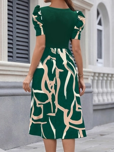Detail view of the back of a slim fit puff sleeve dress with abstract floral print