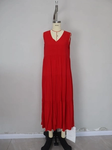 Detailed view of red sleeveless maxi dress with tiered cake skirt and V-neck design