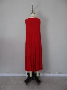 Detail view of the tiered layered hem on this elegant red sleeveless maxi dress