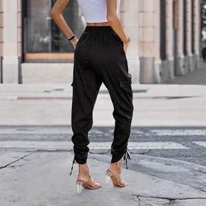 Rear view of black cargo pants with elastic high waist and adjustable drawstring cuffs
