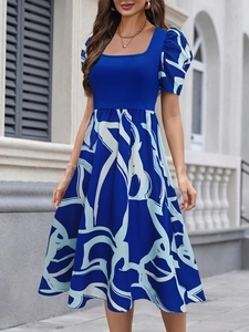 Detail of royal blue puff sleeve dress with square neck and abstract white print