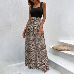 Detailed shot of leopard print wide-leg trousers with high-waist bow tie belt