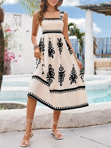 Bohemian off-white smocked midi dress with bold black ethnic print for beach vacations