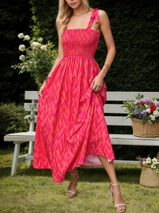 Floral A-line summer dress with pink orange wavy patterns and smocked bodice detail