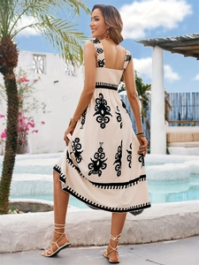 Detail of smocked back and ethnic print on a cream-colored backless summer midi dress