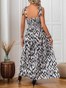 Detailed back view of a chevron print summer dress featuring tied straps and smocked bodice