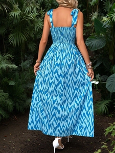 Detailed back view of a blue zigzag print sundress with adjustable bow straps