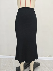 Detailed view of the fine pleated wave texture on the elegant black mermaid skirt