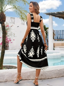 Rear view of a black summer maxi dress with white boho floral prints and smocked waist