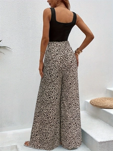 Women's black sleeveless top with high waist leopard print wide leg pants outfit back view