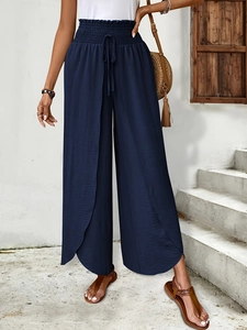 Detail of dark blue high-waisted wide-leg pants with elastic drawstring and front slit