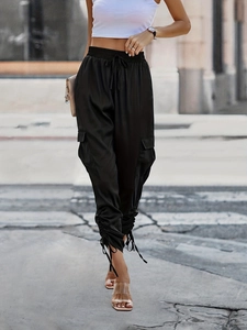 Women's black high-waisted cargo pants with elastic waist and unique ankle tie details
