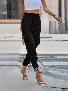 Women's black high-waisted satin cargo joggers with large pockets and drawstring cuffs