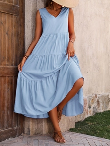 Detail of light blue sleeveless tiered maxi dress with V-neckline and textured fabric