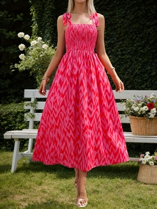 Detail of fuchsia geometric sundress featuring smocked bodice and ribbon shoulder straps