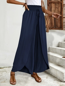Detail of navy wide-leg pants with elastic drawstring waist and layered split hem