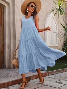 Close-up of the elegant tiered hem and light blue fabric on the V-neck summer dress