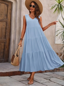 Close-up of light blue V-neck tiered dress with sleeveless cut and flowing hem