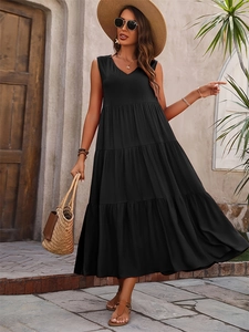 Detail of elegant black sleeveless V-neck tiered maxi dress in a summer vacation setting