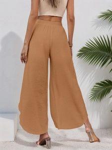 Detailed back view of caramel high-waist wide-leg trousers with natural pleated texture