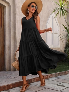 Close-up of tiered layered hem on black sleeveless V-neck maxi dress for summer vacations