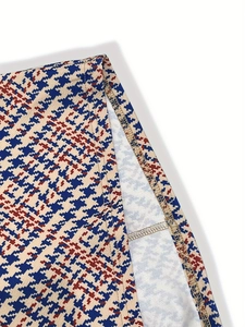Close-up of multi-color houndstooth pattern fabric with neat overlock stitching detail