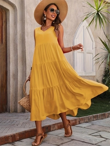 Detail of elegant ginger yellow tiered hemline on a sleeveless V-neck summer dress