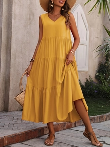 Detail of elegant mustard yellow tiered maxi dress with V-neck and sleeveless design