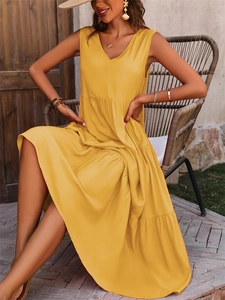 Detail of tiered yellow V-neck maxi dress showing layering and summer fabric texture