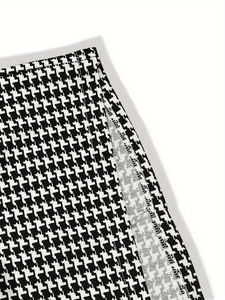 Detail of houndstooth skirt showing side slit and high-quality internal stitching