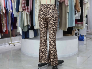 Close-up of leopard print flare pants with high-waist design and elastic knit fabric