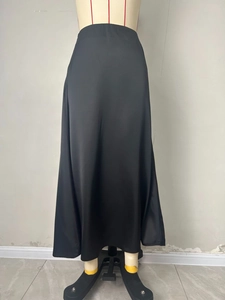 Detail van zwarte satijnen midi-rok met hoge taille, elegante zijdeglans en textuur