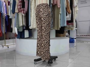 Detail view of high-waisted leopard print flared trousers with elastic stretch fabric
