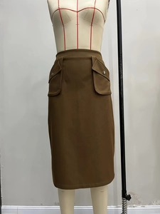 Dark brown high waisted midi skirt with cargo flap pockets and elastic waist utility style