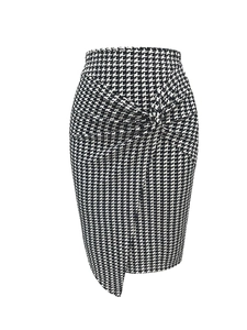 Detail of elegant black and white houndstooth skirt with twisted knot and asymmetric hem