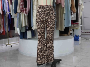 Close-up of leopard print bell-bottom pants showing the flared leg and elastic fabric
