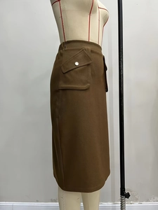 Detail of cargo skirt side pocket with silver metal buckle and flap closure