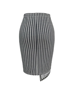 Detailed view of high waist houndstooth skirt with irregular hem and side slit detail