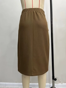 Brown mid-length cargo skirt with elastic waist and textured fabric on mannequin