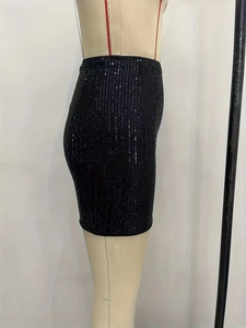 Close-up of black sequin mini skirt showing shimmering texture and elastic high waist