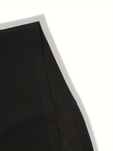 Detailed macro view of the premium black knit fabric with reinforced side seam stitching