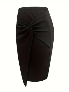 Close-up of elegant black pencil skirt featuring a twisted knot front and wrap-style detail