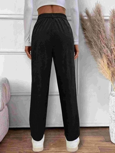 Women's black corduroy high waist straight pants shown from a rear model view