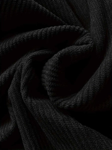 Macro detail of high-density black corduroy fabric showing vertical ribbed texture