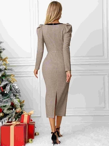 Elegant French plaid knit dress with puff sleeves and back slit in festive setting