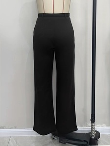 Rear view of high-waisted black straight trousers with premium draped fabric on a mannequin